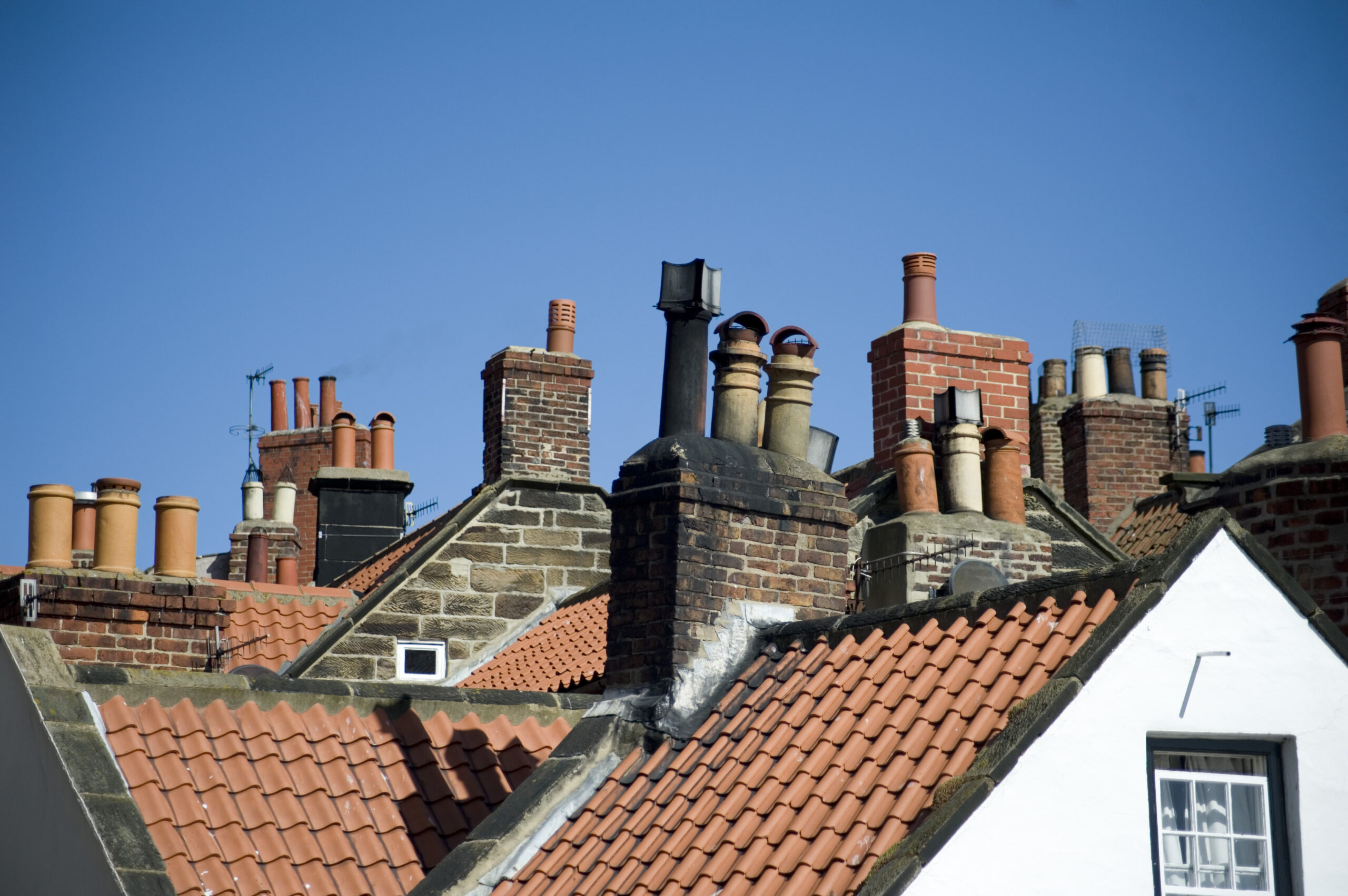 Variety of chimney pots in Robin Hoods Bay Rooftop view of a variety of different chimney pots on quaint cottages in the fishing village of Robin Hoods Bay, UK